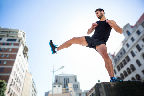 istock Handsome athlete kicking in the air 666930570