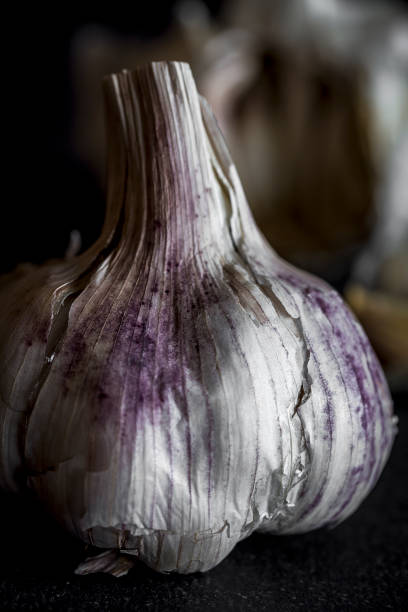 Fresh garlic on old black wood table.Detox Fresh garlic on old black wood table.Detox Artichoke stock pictures, royalty-free photos & images