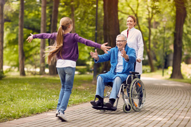 istock cheerful grandchildren visiting disabled father in park 666934732