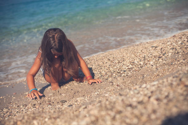 istock Little Girl Playing at the Beach 666935772