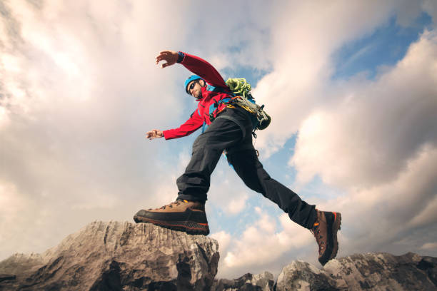istock Hiker jumps on the rock 666936094