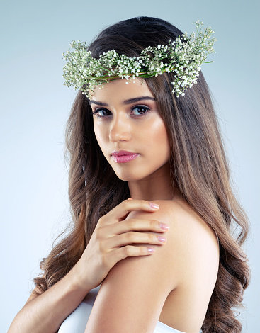 Studio shot of a beautiful young woman wearing a floral head wreath