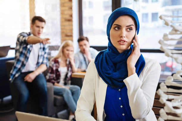 istock PlGroup of students abusing pleasant muslim female student 666939508