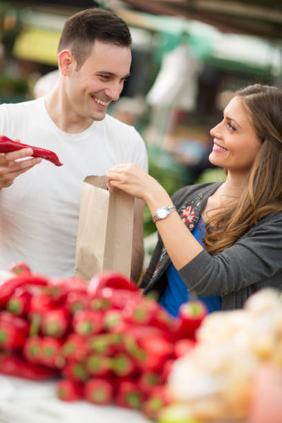 istock Couple choosing red pepper in grocery store 666939770