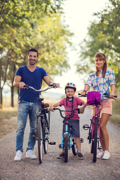 istock Smiling parents and son on bicycles in nature. 666942288