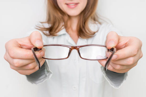 istock Optometrist giving new eyeglasses to patient 666942320