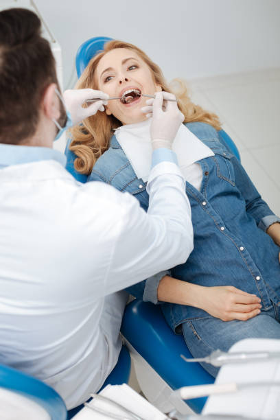 istock Young charming lady undergoing a dental checkup 666942750
