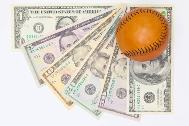 istock Leather baseball ball and us dollar banknotes 666942768