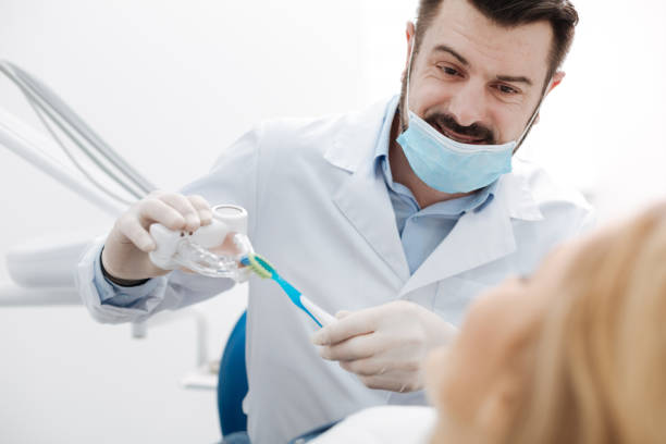 istock Lovely charismatic dentist giving a little training lesson 666943032
