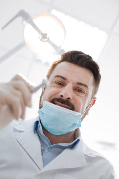 istock Enthusiastic pleasant dentist doing his job 666943200