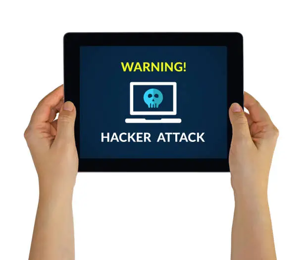 Photo of Hands holding tablet with hacker attack concept on screen