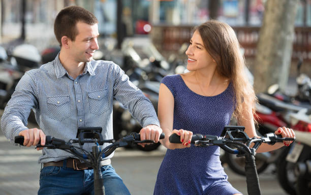 istock Happy young man and woman with electrkc bikes 666943312