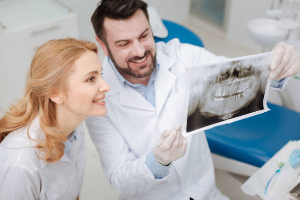 istock Charming young dentist sharing the progress of his patient 666946354