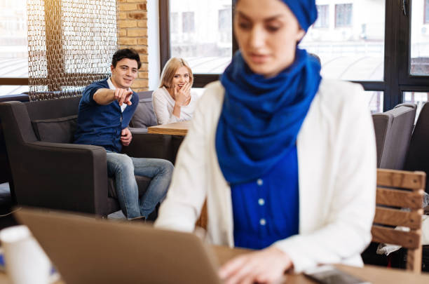 istock Joyful students humiliating muslim woman 666947116