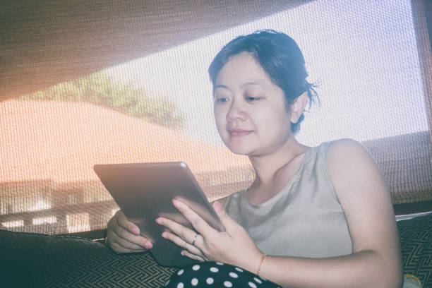 istock Beautiful woman using digital tablet in vaction 666947302