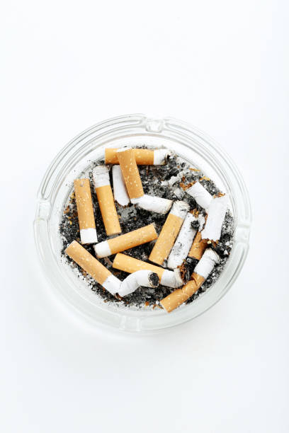 istock Cigarette butts with ash in ashtray isolated on a white 666947362