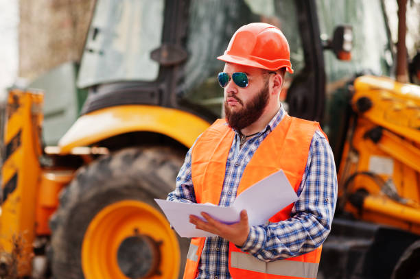 istock Brutal beard worker man suit construction worker in safety orange helmet 666947872
