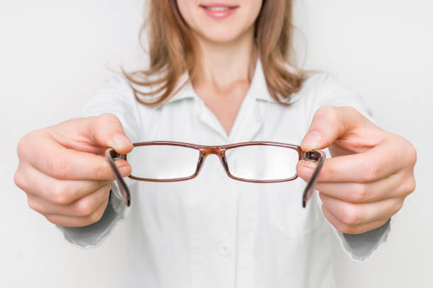 istock Optometrist giving new eyeglasses to patient 666949864