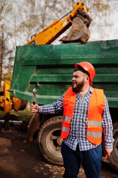 istock Brutal beard worker man suit construction worker in safety orange helmet 666950074