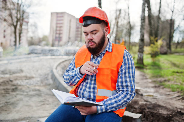 istock Brutal beard worker man suit construction worker in safety orange helmet 666950194