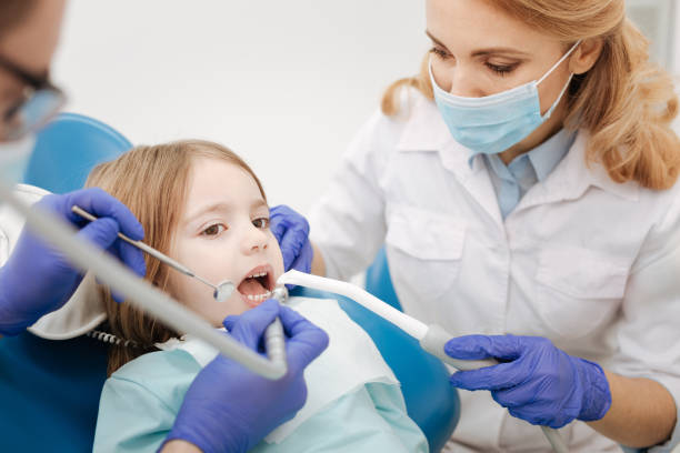 istock Caring gentle nurse assisting a dentists 666950616