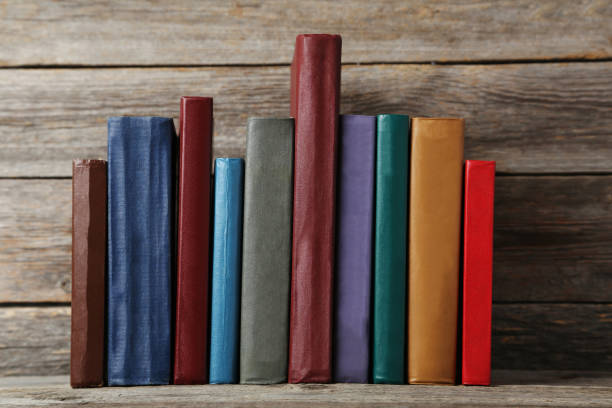 istock Old antique books on grey wooden table 666950804