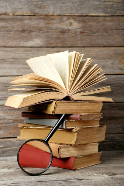 istock Old antique books on grey wooden table 666951326