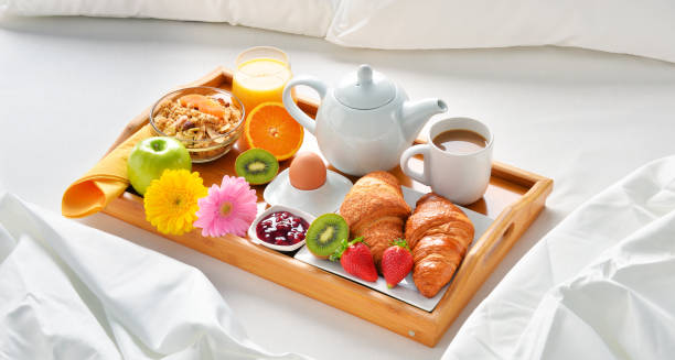 istock Breakfast tray in bed in hotel room 666953942