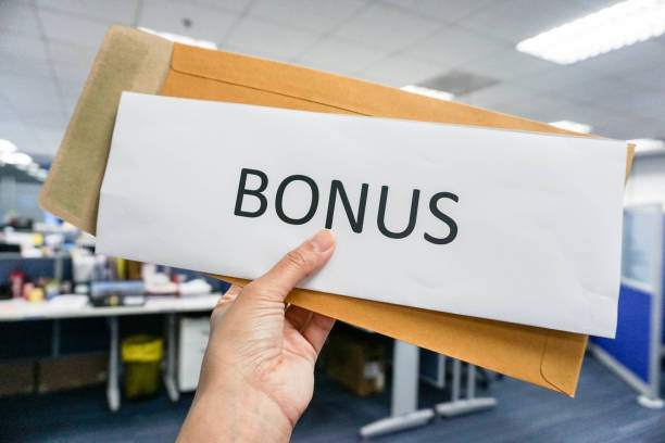 concept of bonus by pulling paper of bonus from the envelope stock photo