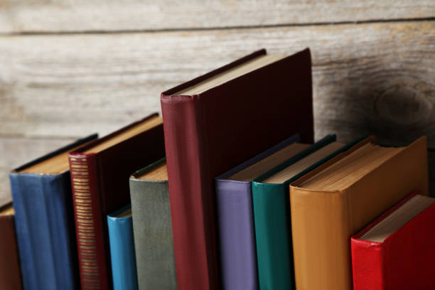 istock Old antique books on grey wooden table 666954358