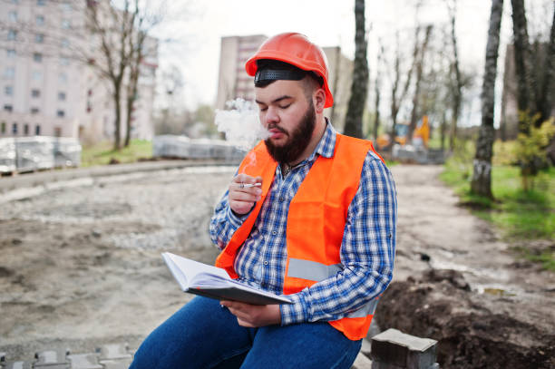 istock Brutal beard worker man suit construction worker in safety orange helmet 666954724