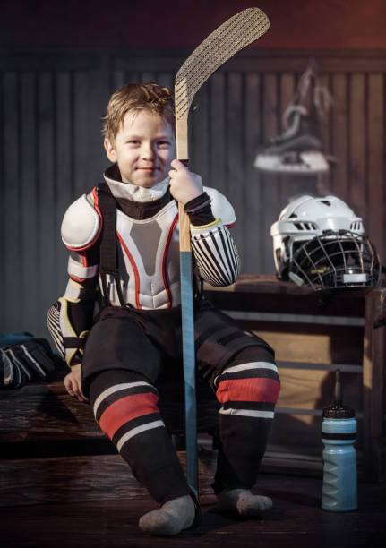 istock Happy Little Hockey Player Resting After Game 666954882