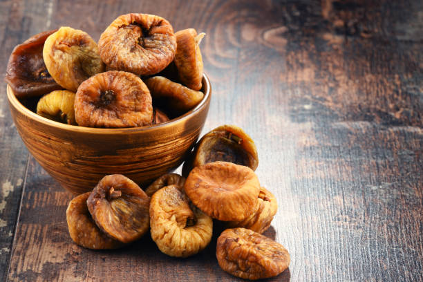 istock Composition with bowl of dried figs on wooden table 666955226