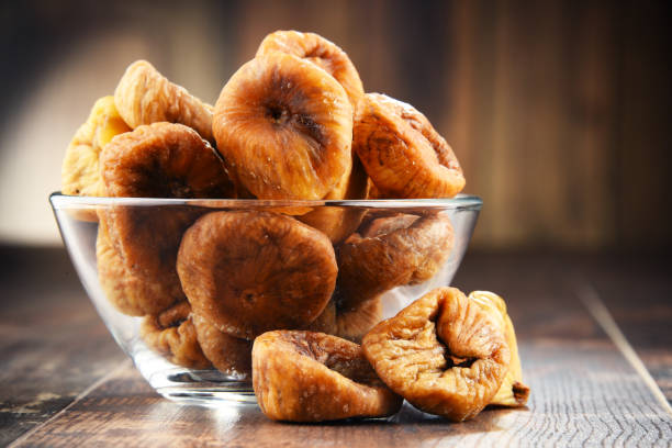 istock Composition with bowl of dried figs on wooden table 666955354