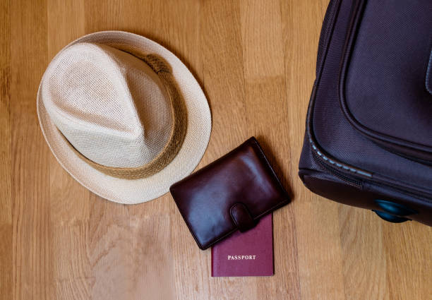 istock Hat, wallet, passport, suitcase prepared for the trip 666955520