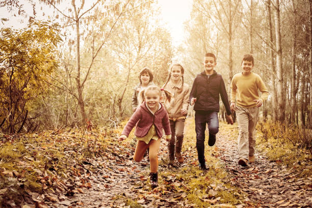 istock Children running together in a park. 666959762