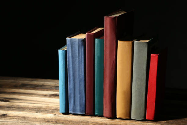 istock Old antique books on brown wooden table 666960678