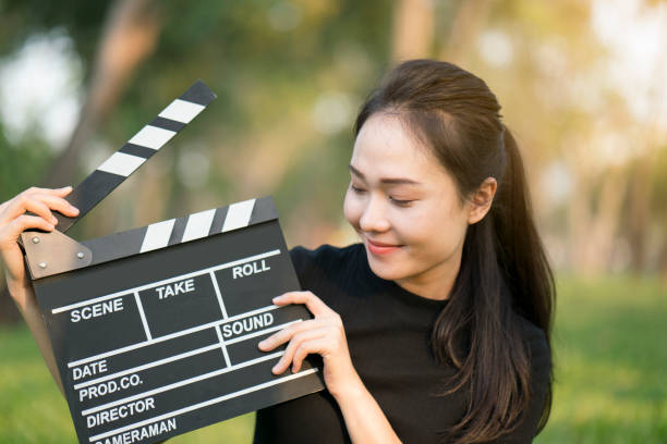 istock asian girl holding clapper board in her hands 666960920