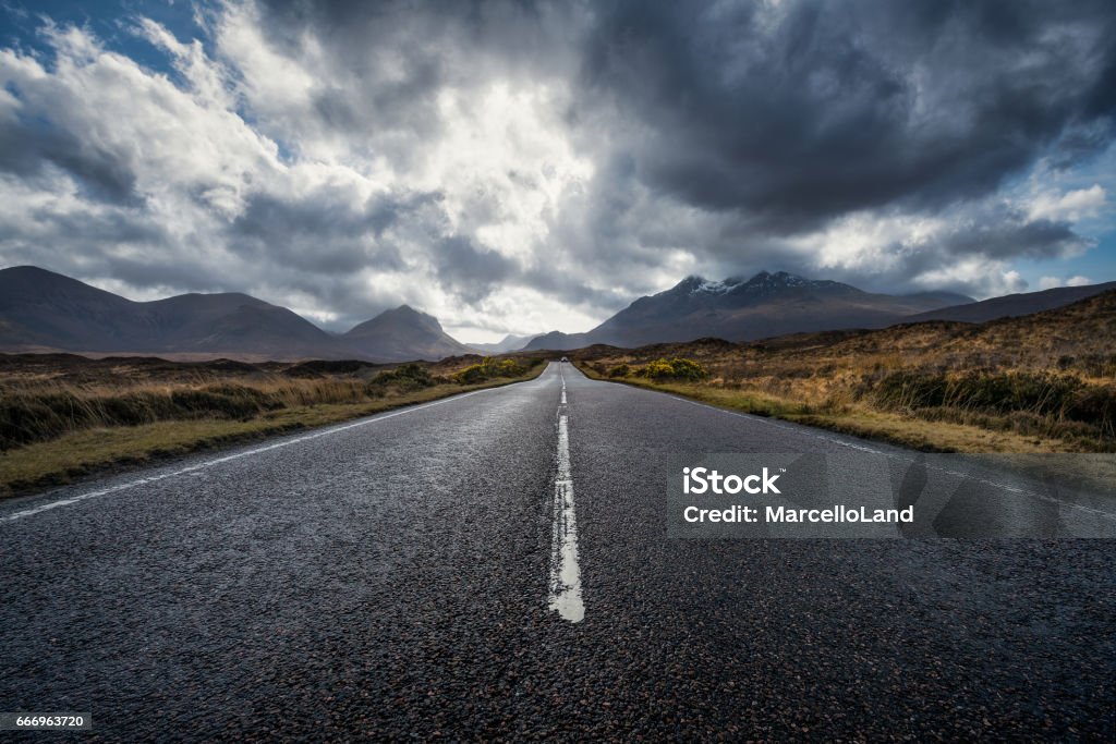 On the road, Isle of Skye, Scotland, UK Isle of Skye, Scotland, UK. Skye, or the Isle of Skye (/skaɪ/; Scottish Gaelic: An t-Eilean Sgitheanach or Eilean a' Cheò), is the largest and northernmost of the major islands in the Inner Hebrides of Scotland. The island's peninsulas radiate from a mountainous centre dominated by the Cuillins, the rocky slopes of which provide some of the most dramatic mountain scenery in the country. Although it has been suggested that the Gaelic Sgitheanach describes a winged shape there is no definitive agreement as to the name's origins. Road Stock Photo