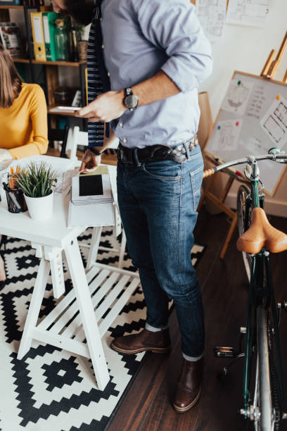 istock Bearded man in business clothes is looking at the blueprints 666964904