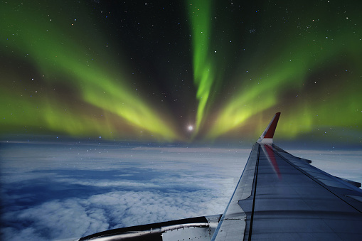 Aerial view of Northern Lights (Aurora Borealis) from window of an flying airplane