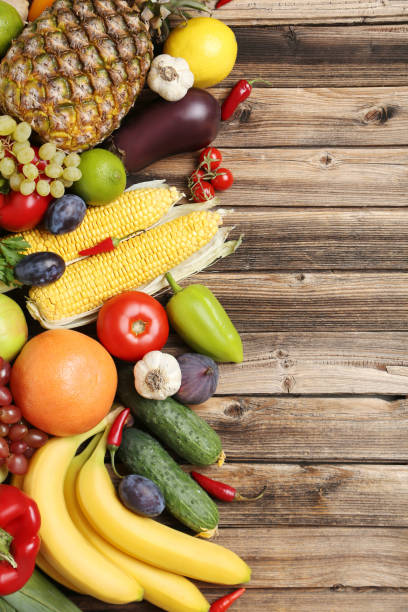 istock Ripe fruits and vegetables on wooden table 666969242