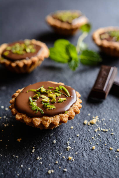 istock Tartlets with chocolate, pistachios and lime peel 666975494
