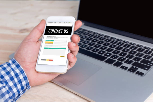 istock Hand holding smartphone and showing Contact Us page 666979862