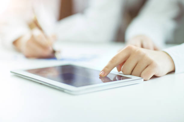 istock businessman using digital tablet, working with the financial schedule at the Desk 666980042