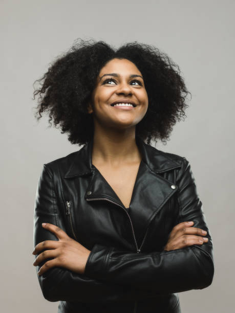 istock Cheerful black woman looking up and smiling 666985356