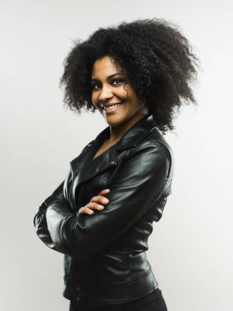 istock Smiling african woman looking at camera on gray background 666987444