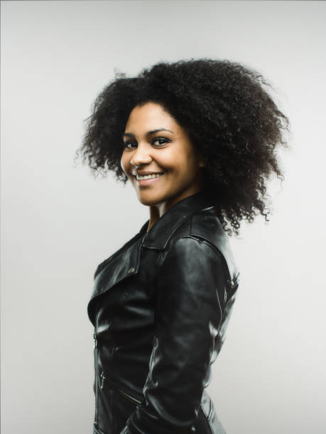 istock Smiling african woman looking at camera on gray background 666987522