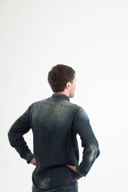 istock rear view of a stylish young man looking forward to the empty sp 666987916