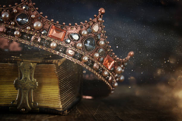 istock low key image of beautiful queen/king crown on old book 666989168